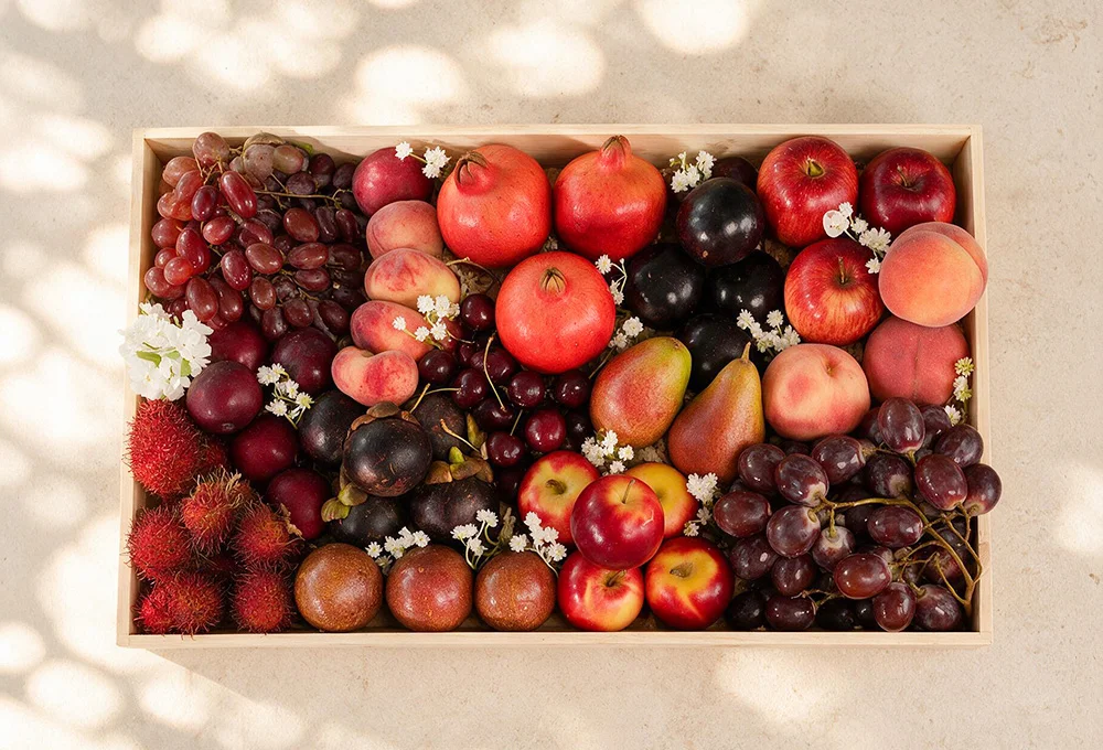 Red Seedless Grape, Donut Peach, Pomegranate, China Plum, Mini Apple, Rambutan, Mangosteen, Cherries, Red Beauty Pear, Spanish Peach, Rockit Apple, Red Globe Grape, and Passion Fruit.