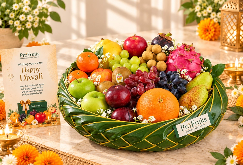 Premium leaf basket filled with exotic fruits including Black Grapes, Dragon Fruit, Egyptian Mangoes, Golden Kiwi, Mangosteen, Apples, Pears and a Diwali greeting card