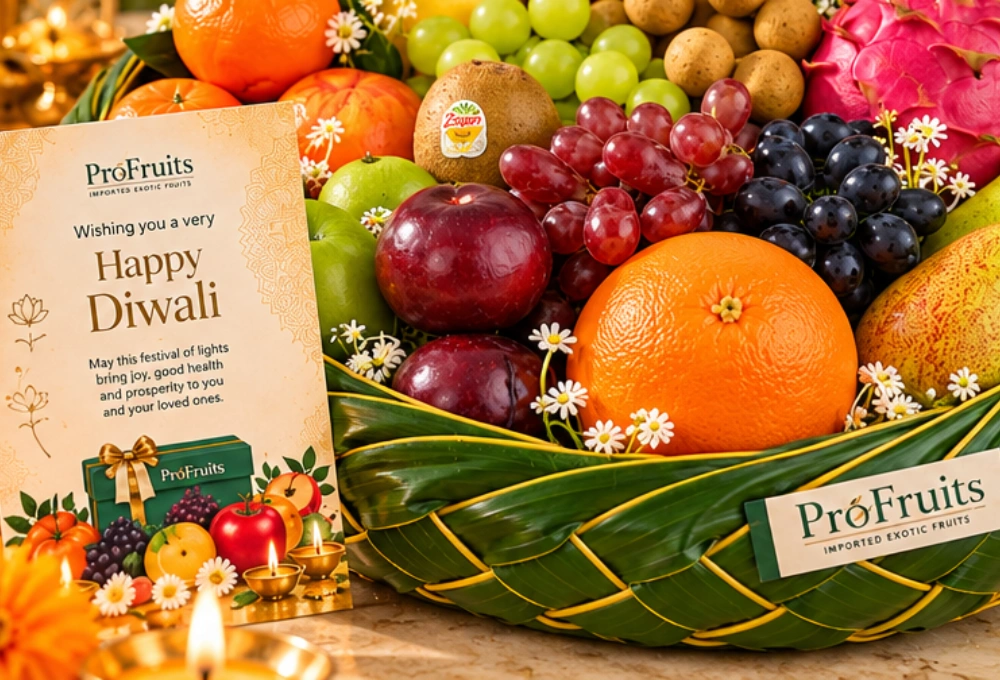 Premium leaf basket filled with exotic fruits including Black Grapes, Dragon Fruit, Egyptian Mangoes, Golden Kiwi, Mangosteen, Apples, Pears and a Diwali greeting card