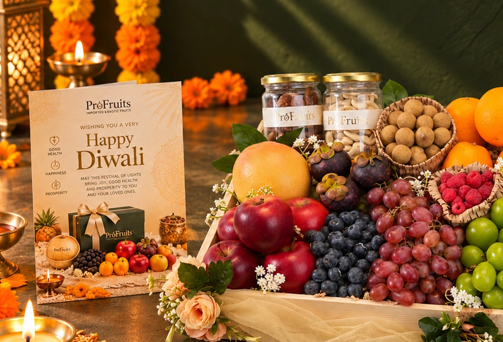 Rockit Apple, Grapefruit, Mangosteen, Longan, Blueberries, Red Seedless Grapes, Valencia Orange, Whole Honey Pineapple, Red Beauty Pear, Mulberries, Raspberries, Green Muscat Grapes, Cashew Jar, and Fig Jar with a Wooden Tray & Happy Diwali Greeting Card.