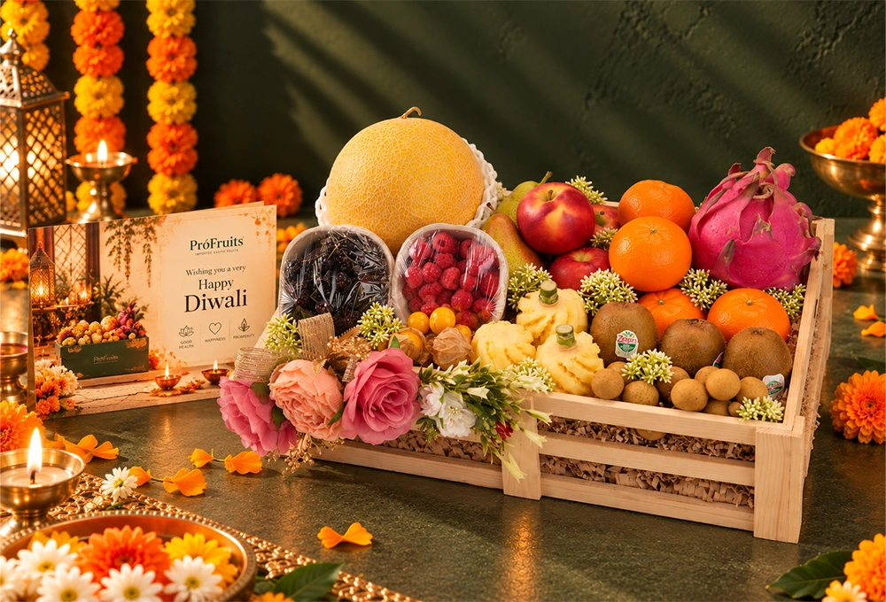 Golden Kiwi, Golden Emerald Muskmelon, Red Beauty Pear, Rockit Apple, Kutch Dragon Fruit, Murcott Orange, Longan, Honey Pineapple, Gooseberry, Mulberry, and Raspberry with a Wooden Tray & Happy Diwali Greeting Card.