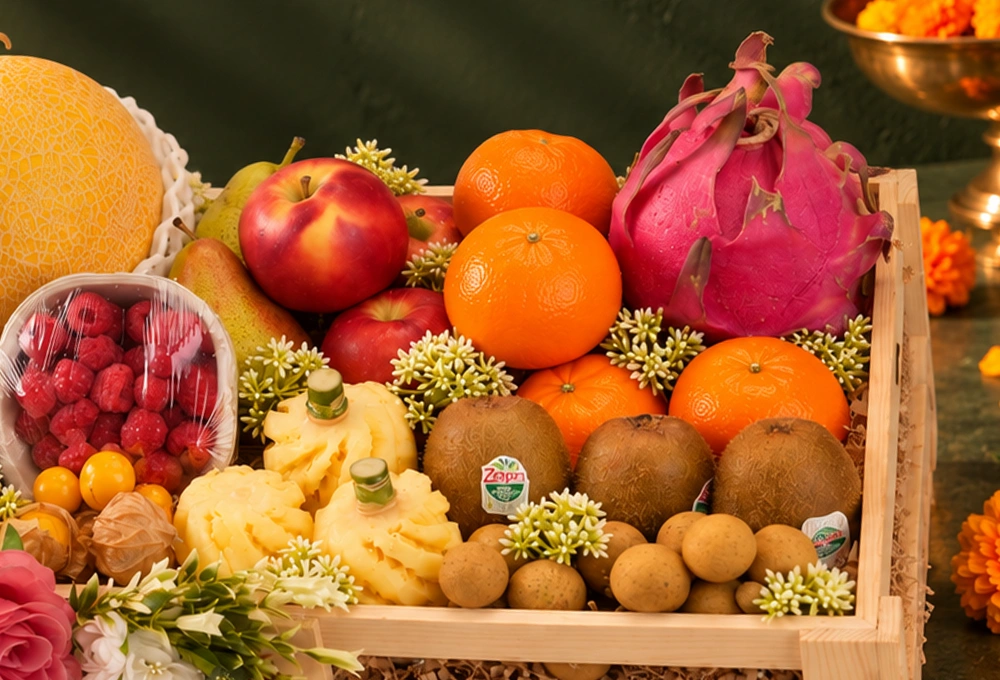 Golden Kiwi, Golden Emerald Muskmelon, Red Beauty Pear, Rockit Apple, Kutch Dragon Fruit, Murcott Orange, Longan, Honey Pineapple, Gooseberry, Mulberry, and Raspberry with a Wooden Tray & Happy Diwali Greeting Card.