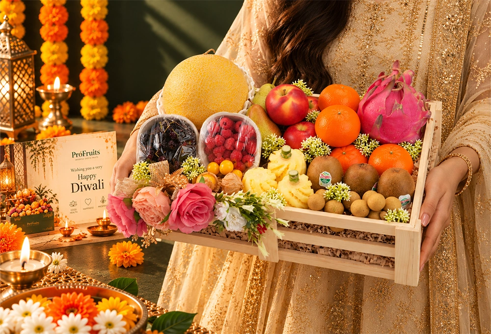Golden Kiwi, Golden Emerald Muskmelon, Red Beauty Pear, Rockit Apple, Kutch Dragon Fruit, Murcott Orange, Longan, Honey Pineapple, Gooseberry, Mulberry, and Raspberry with a Wooden Tray & Happy Diwali Greeting Card.