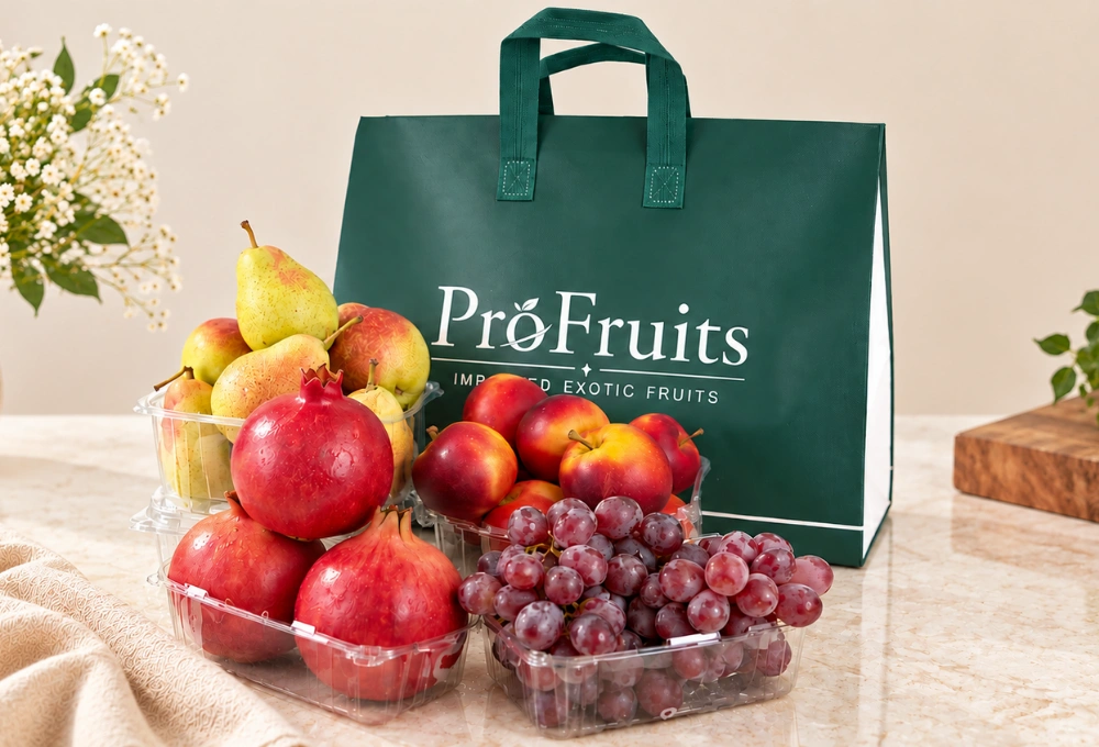Fruit gift bag featuring Red Beauty Pears, XL Pomegranate, Red Globe Grapes and Rockit Apples.