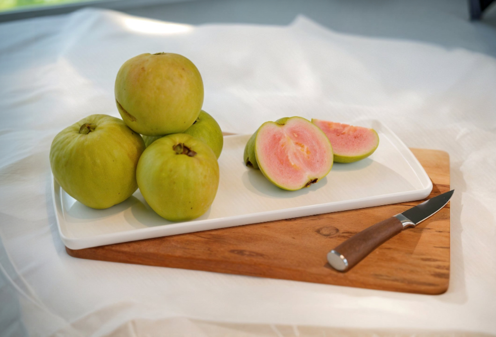 Fresh pink guava with vibrant pink pulp and green outer skin