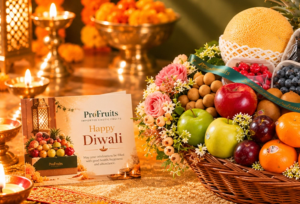 Green Apple, Murcott Orange, Golden Kiwi, Red Ice Guava, China Plum, Green Muscat Grapes, Mangosteen, Green Vermont Pear, Red Apple, Grapefruit, Pink Guava, Red Seedless Grapes, Kutch Dragon Fruit, Blueberries, Mulberries, Raspberries, Longan, Whole Pineapple, Golden Emerald Muskmelon, and Avocado with a Basket & Diwali Greeting Card.